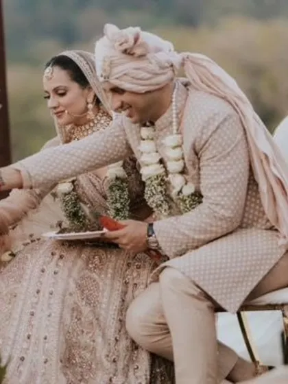 A candid moment during the wedding rituals. The makeup is designed to look flawless and natural throughout the ceremony.