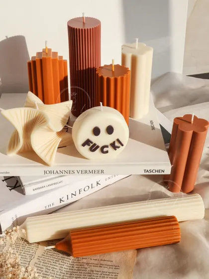 A collection of my modern pillar candles in warm, earthy tones.