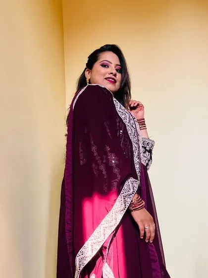 Arshiya looking stunning in her party outfit. The makeup features a dramatic wine-colored eyeshadow and a matching bold lip.