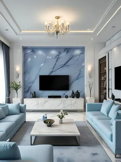 A cool and sophisticated living room with a blue marble accent wall behind the TV. The light blue sofas and grey rug create a serene and modern color scheme, offering a tranquil space for relaxation.