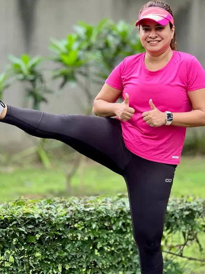 A member showing off her flexibility with a post-run stretch. We encourage a holistic approach to fitness that goes beyond just running.