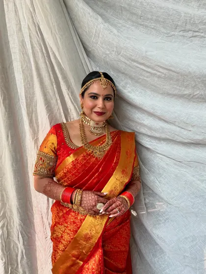 A serene and graceful portrait. The soft, brown matte eyes and red lip are a classic combination that never goes out of style.
