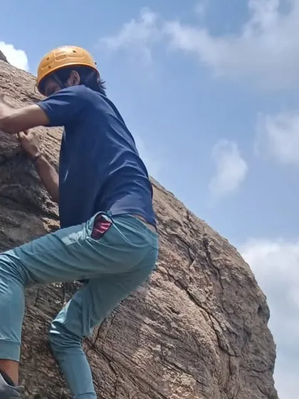 A close-up of a young participant focused on his climb, showcasing the determination and concentration that climbing helps to develop.