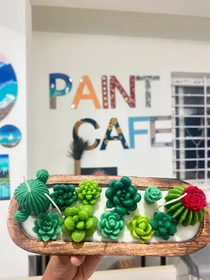 A unique succulent garden candle in a wooden tray, showcasing the creative possibilities with wax.