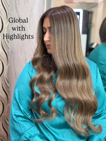 A beautiful example of a global color with highlights. The base is a soft beige blonde, lifted with brighter blonde pieces.