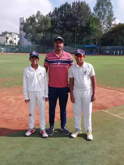 A coach and two young players, representing the future of our academy.