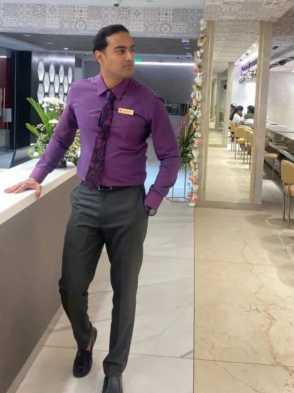Purple shirt, tie and a clean shave make up my corporate-character look in this full-length formal portrait.