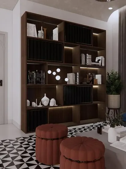 The custom-built bookshelf serves as a major focal point in this lounge, offering ample storage and display space. The design combines functionality with bold aesthetic choices for a truly unique room.