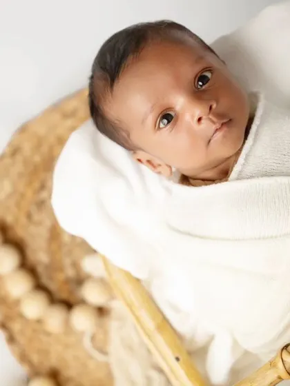 A close-up shot capturing the newborn's beautiful, wide eyes. These moments of connection are incredibly special to capture.