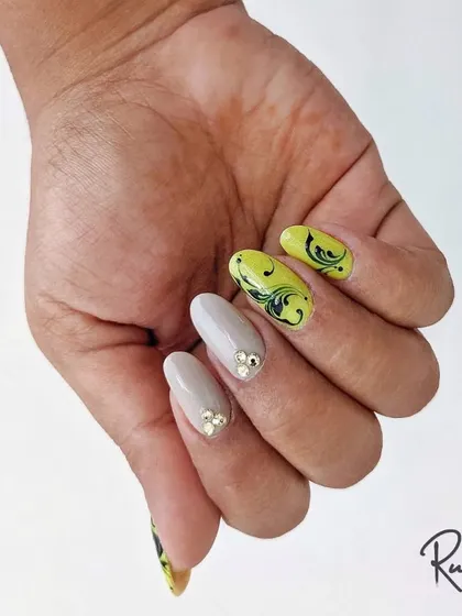 A full hand view of the neon swirl and crystal design, showing how I balance bold art with simpler, elegant nails for a cohesive look.