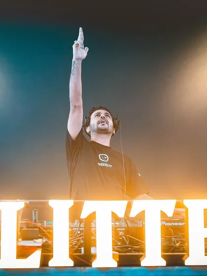 One hand to the sky. A classic pose that signals a massive anthem is about to drop.