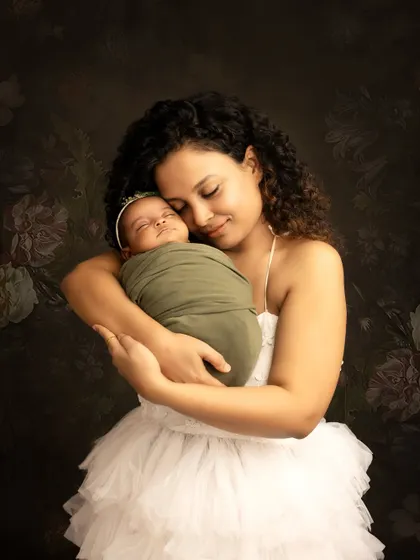A mother's gentle embrace. This close-up shot focuses on the intimate bond between a mother and her newborn baby, creating a deeply emotional portrait.