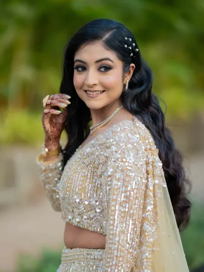 Glowing in gold. This look is all about enhancing her natural beauty with soft eyes, radiant skin, and a touch of sparkle.