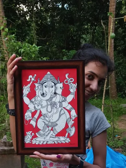 Here I am, holding my framed Kalamkari painting of a five-headed Ganesha. It brings me great joy to see a piece completed and ready to find a new home.