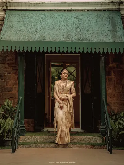 A beautiful moment of connection between the bride and groom. Their coordinated golden attire shines in this elegant portrait taken at Chamaravarjra.