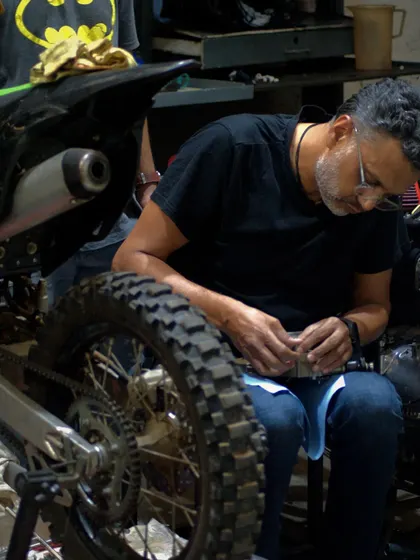 Getting my hands dirty, working on the fine details of a dirt bike in the garage. This is what we love to do, whether it's a simple tune-up or a full engine rebuild.