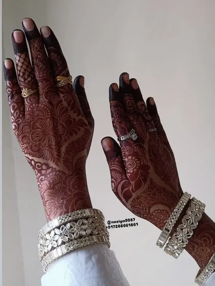 The beautiful dark stain of a bridal henna, adorned with rings and bangles. This is the complete look that every bride dreams of.