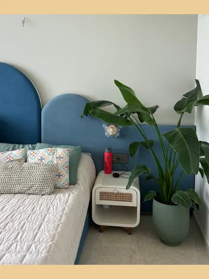 A Bird of Paradise plant brings a touch of green to a modern bedroom. Placing a plant by the bedside can improve air quality and create a calming atmosphere to start and end your day.