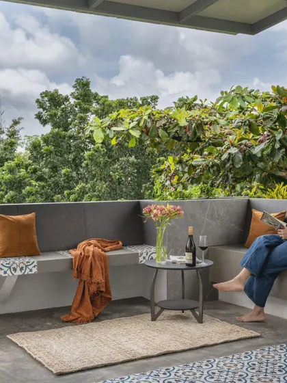 The terrace, adjacent to the lounge, is perfect for unwinding. Surrounded by greenery, it features built-in seating that provides ample space for parties and spillover from the indoor lounge.