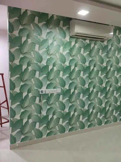 A bright and airy room with a large green leaf wallpaper. The design makes the space feel fresh and connected to nature.
