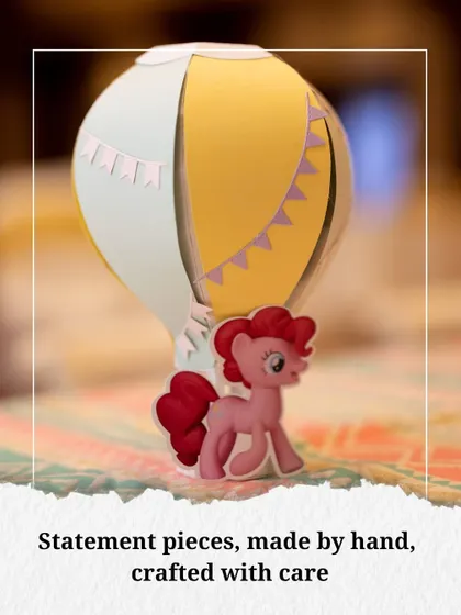 Statement pieces, made by hand and crafted with care. This hot air balloon centerpiece, featuring a beloved pony character, added a touch of handmade charm to the tables.