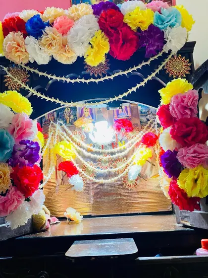 I decorate home mandirs to make them look special for any pooja or festival. This wooden mandir is decorated with colorful artificial flowers and traditional pearl strings.