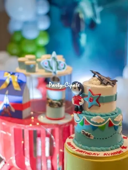More details from the fighter jet party cake table. The custom cake and themed props create a cohesive and exciting display.