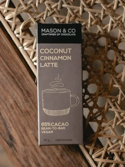 The clean, elegant design of our collaboration chocolate bar, resting on a woven chair. Every detail, from the flavour to the packaging, was thoughtfully considered.