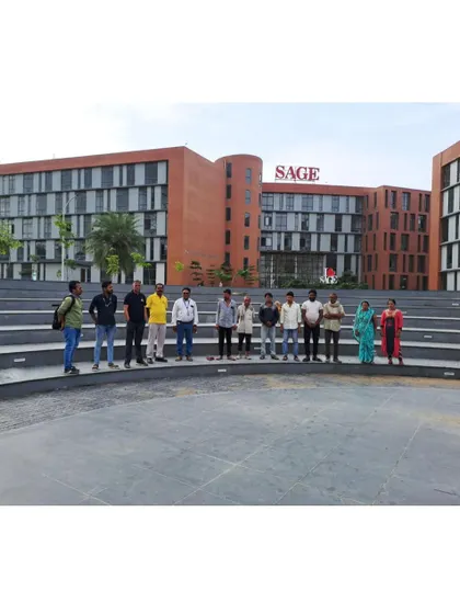A team of architects and engineers on site at the Sage University campus, standing in the amphitheater. This image captures the collaborative effort required to bring such a large-scale institutional project to life.
