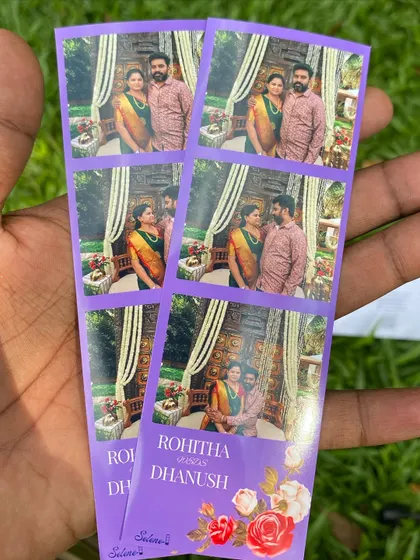 A close-up of a custom photo strip designed for a wedding, featuring the couple's names and a beautiful floral motif. I work with you to create a design that perfectly matches your wedding stationery and theme.