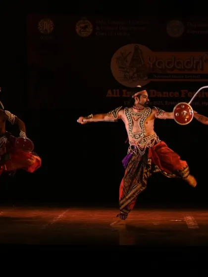 A Chhau dancer in mid-motion, brandishing a sword and shield. This action shot captures the essence of the dance as a narrative of warriors and their heroic deeds.