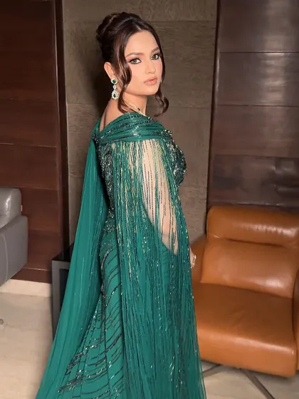 A side profile showcasing the intricate hairstyle and the way the makeup catches the light. The subtle contouring and highlight on the cheekbones add dimension and ensure the look is stunning from every angle.