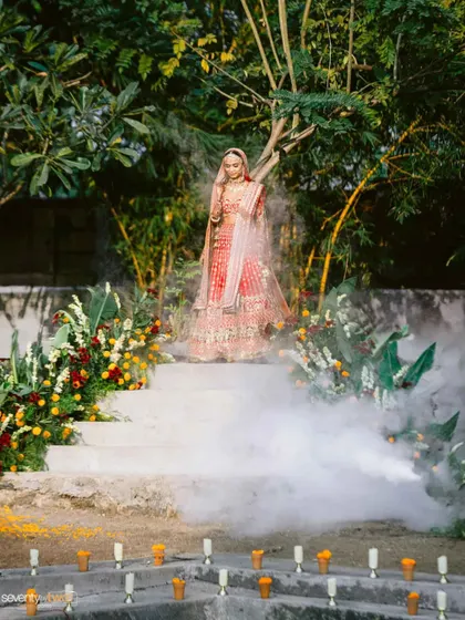The bride's dramatic entrance down a smoke-filled staircase to the 'kund' where her wedding ceremony will take place. A truly magical and unforgettable moment.