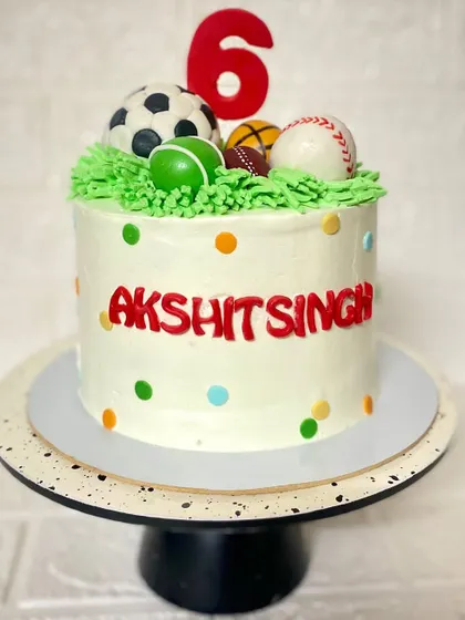 A full view of the multi-sport themed cake, perfect for a 6th birthday.