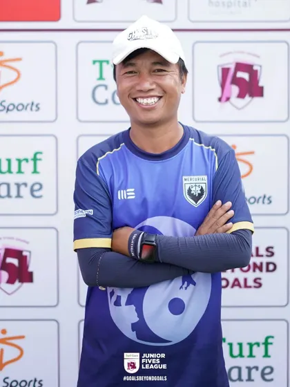 A smile that shows a love for the game. This coach's positive energy is infectious and helps inspire his young players.