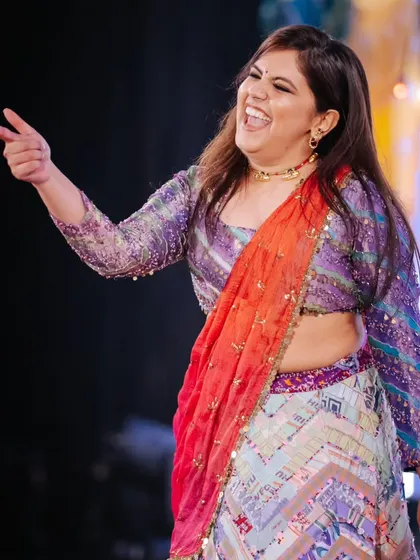 A candid shot of our choreographer enjoying the sangeet night, full of laughter and joy.