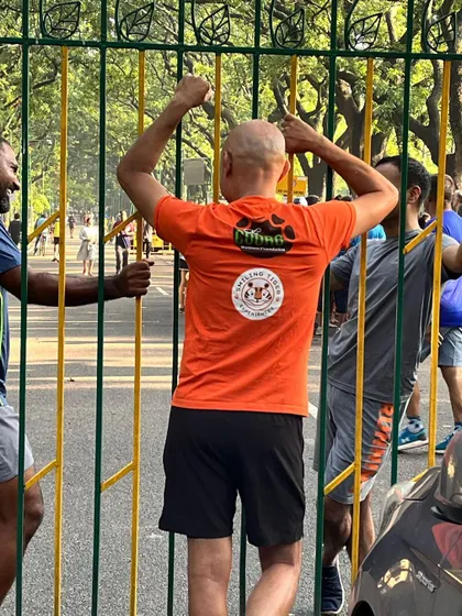 The excitement is real. A participant eagerly waits at the gate for the run to begin, full of energy and anticipation.