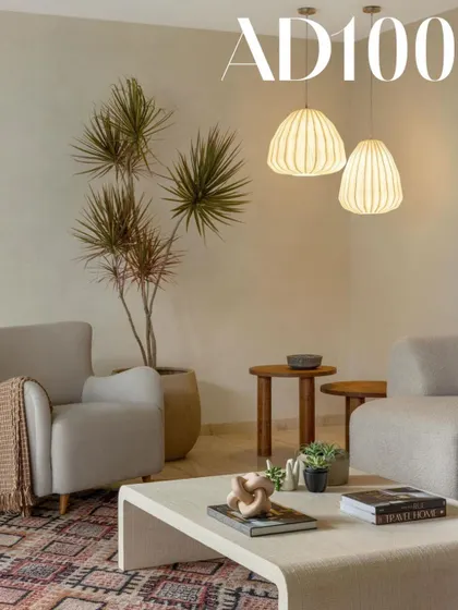 A living room from our AD100 feature, showcasing a warm minimal aesthetic with a focus on texture and sculptural forms.