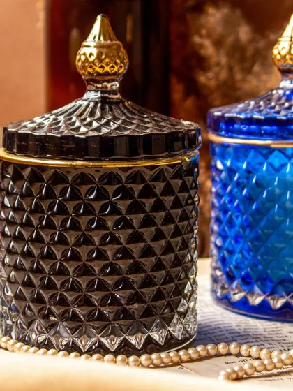 My golden line crystal jar soy candles are designed to add a touch of luxury to your home. This shot shows the elegant black and royal blue jars, which can be filled with any custom fragrance you choose, from cozy Oud to fresh Lily Rose.