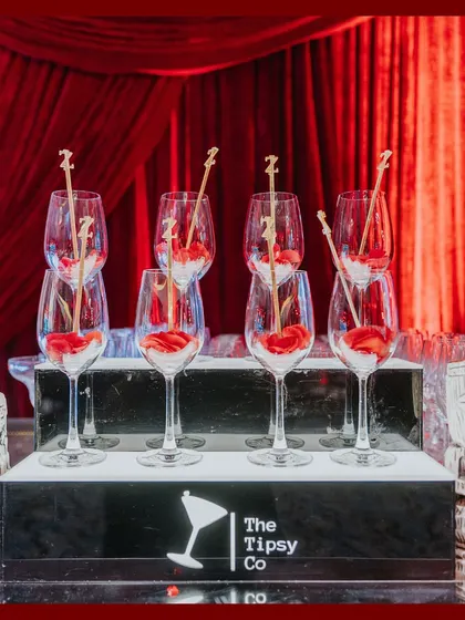 Setting the bar high with an elegant drink display. For this reception, we worked with the bar service to create a beautiful presentation with personalized stirrers and rose petals.