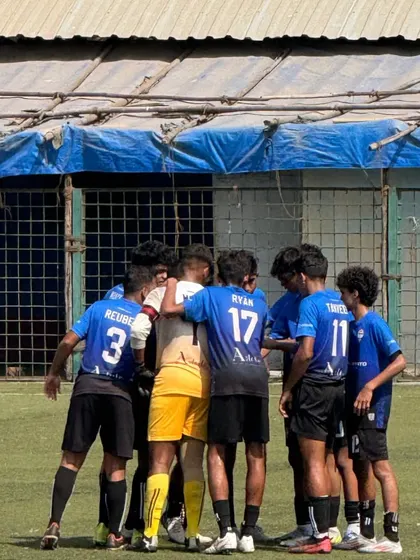 A tight team huddle, showing the unity and focus of our senior squad before a big game.