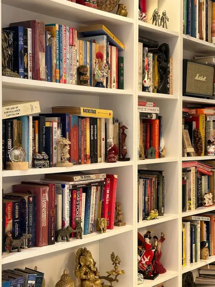Our membrane-finished bookshelves provide a clean and timeless backdrop for a personal collection. Here, the simple white structure allows the owner's books and antiques to become the true focal point, turning a storage unit into a gallery of personal treasures.
