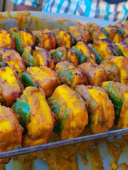A tray of perfectly marinated and grilled paneer tikka with bell peppers, ready to be served to guests from our live counter.