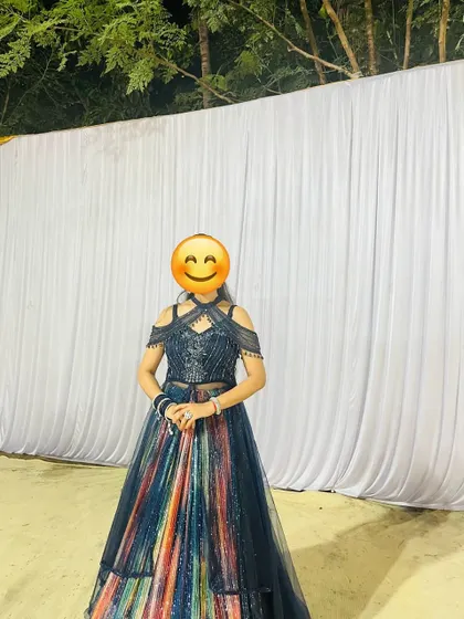 A happy client wearing the multi-colour sequin gown. It's a two-piece set that's perfect for a cocktail or sangeet night.