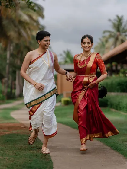 A happy, carefree moment of the couple running hand-in-hand. This dynamic portrait captures their excitement and the joyful start of their new journey together.