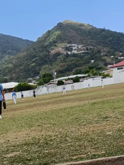 A young player from the CYCA tour in Trinidad, ready for a day of intense training against a beautiful mountain backdrop.