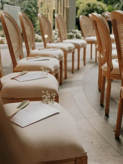 A row of elegantly arranged chairs, each with a personalized program and fan. This demonstrates my commitment to ensuring every single guest's experience is considered.