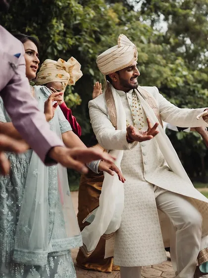 The groom joins in the dancing with guests at the Baraat, creating a fun and energetic start to the wedding festivities.