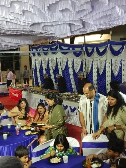 A vibrant housewarming party with guests seated and enjoying their meals. We manage the entire catering so you can enjoy the celebration.