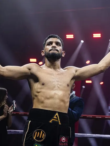 The moment of victory, arms raised, a champion on home soil.